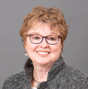 A profile picture of Janet, smiling at the camera