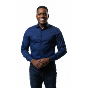 A picture of Sean standing and smiling at the camera
